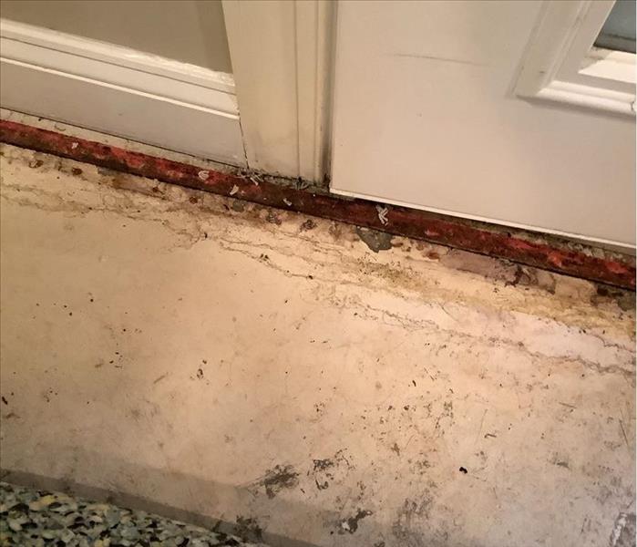 water damage caused by a basement door leak