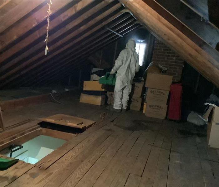 A SERVPRO professional fogging an attic